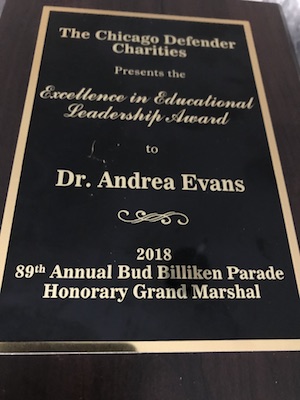 An award plaque presented to Dr. Andrea Evans from the Chicago Defender Charities for Excellence in Educational Leadership